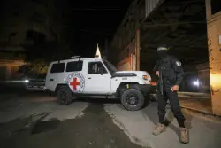 The Latest: Israel says one body handed over wasn’t a hostage as aid trucks head for Gaza
